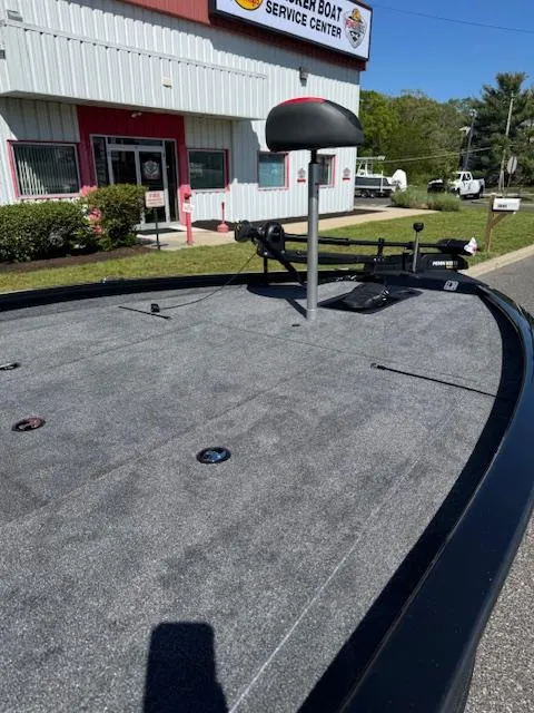 Slide: The Image of 2025 Tracker Savage 215 boat at service center, showcasing spacious deck and modern design. - 12