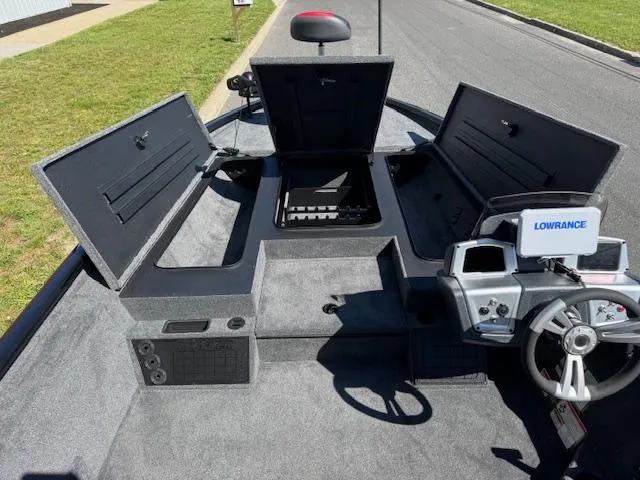 Slide: The Image of 2025 Tracker Savage 215 boat interior with open storage compartments and Lowrance navigation system. - 8