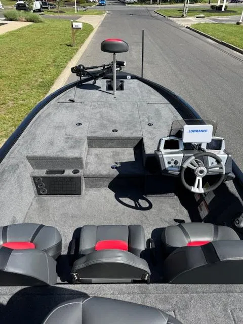 Slide: The Image of 2025 Tracker Savage 215 boat with modern seating and navigation system on a residential street. - 9