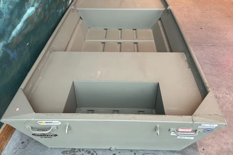 Slide: The Image of 2025 Tracker Grizzly 14 Jon boat, olive green, sturdy design, ideal for fishing and hunting. - 2