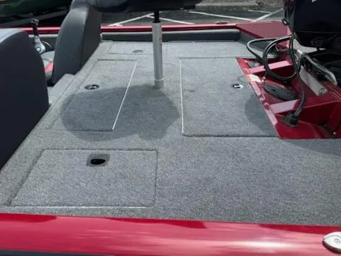 Slide: The Image of 2025 Tracker Pro Team 190 boat deck with gray carpet and storage compartments. - 4