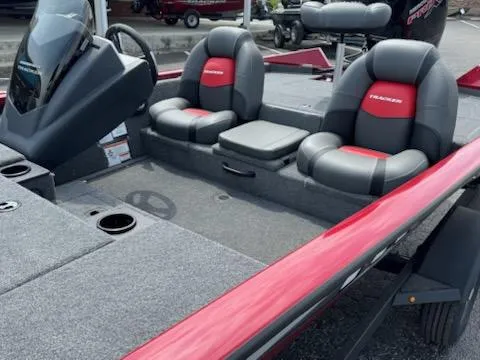 Slide: The Image of 2025 Tracker Pro Team 190 boat interior with red and gray seating, steering console, and storage. - 6