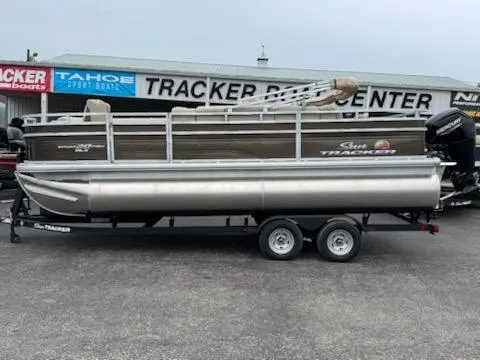The Image of 2025 Sun Tracker SportFish 20 DLX pontoon boat on trailer at dealership. - 0