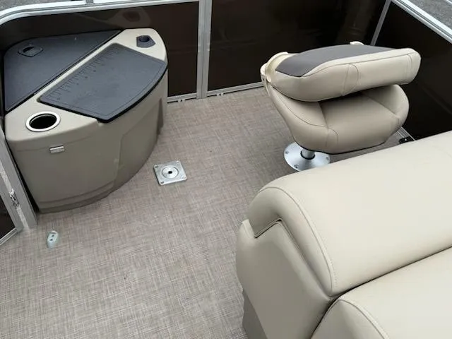 Slide: The Image of 2025 Sun Tracker SportFish 20 DLX boat interior with beige seating and fishing station. - 8