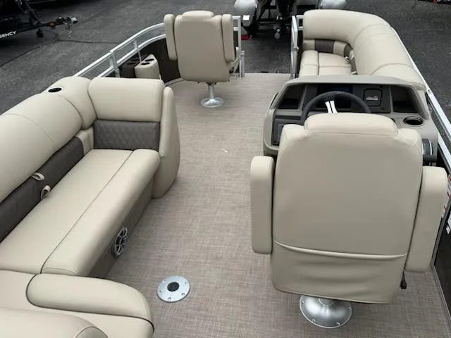 Slide: The Image of 2025 Sun Tracker SportFish 20 DLX pontoon boat with beige seating and spacious interior layout. - 9