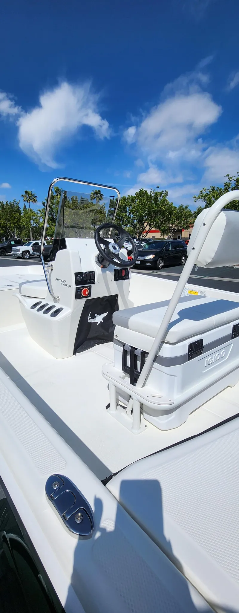 Slide: The Image of 2025 Mako Pro Skiff 17 CC boat with console and seating, under clear blue sky. - 3
