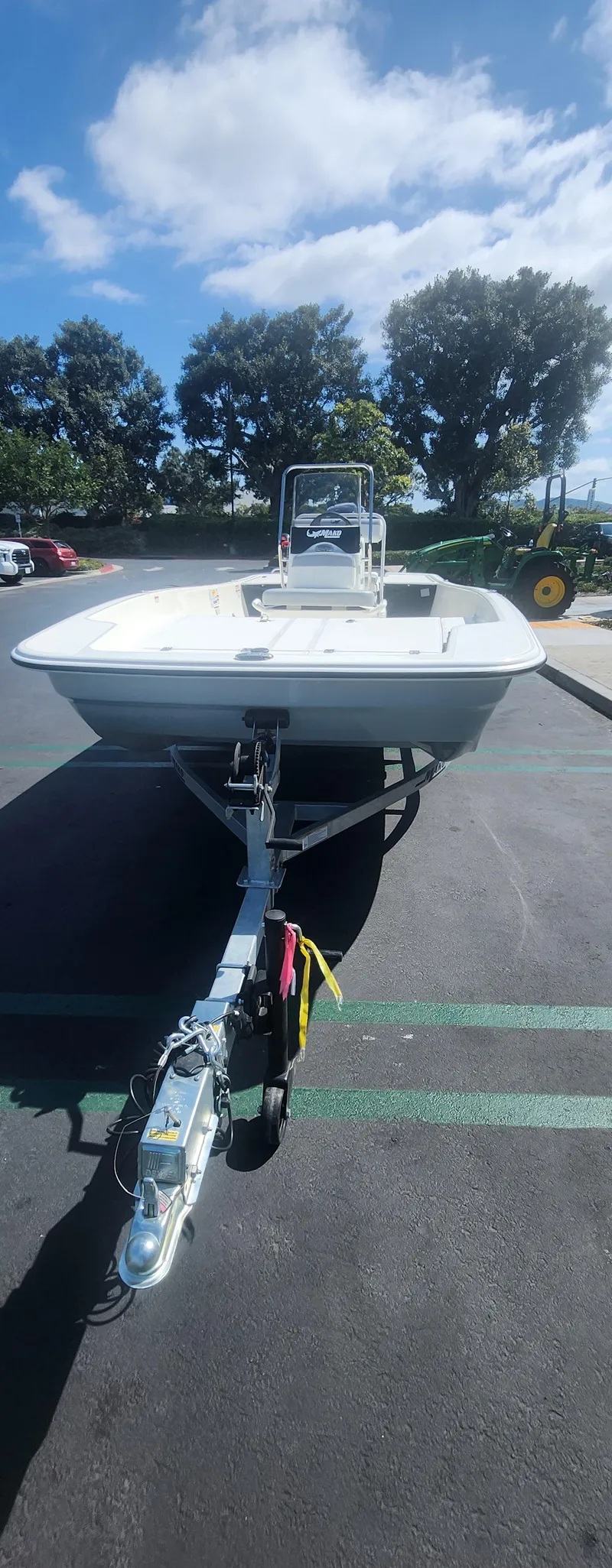 Slide: The Image of 2025 Mako Pro Skiff 17 CC boat on trailer under blue sky. - 4