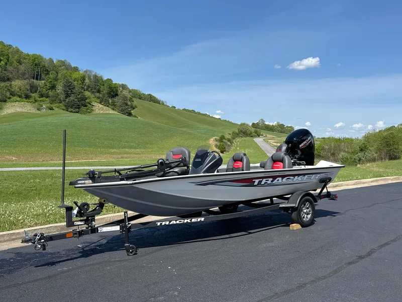 Slide: The Image of 2025 Tracker Pro Team 175 boat on trailer, parked on a scenic road. - 3