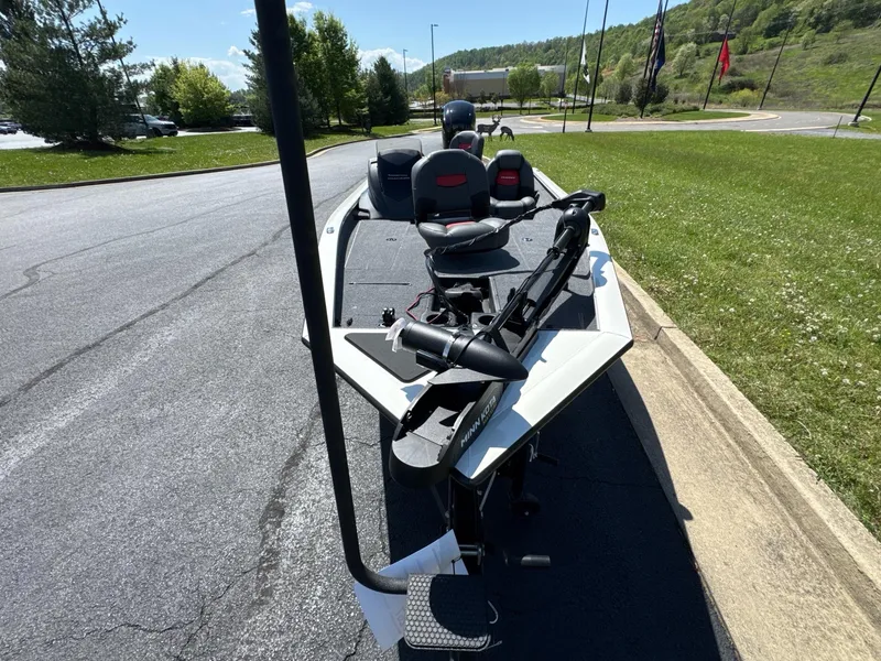 Slide: The Image of 2025 Tracker Pro Team 175 boat parked on a sunny road near grass. - 4