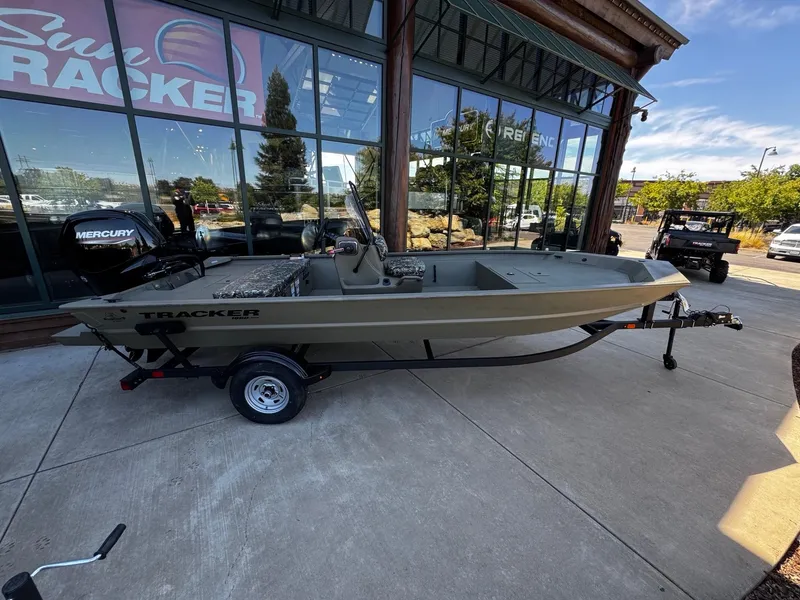 Slide: The Image of 2025 Tracker Grizzly 1860 CC boat on trailer outside dealership. - 2