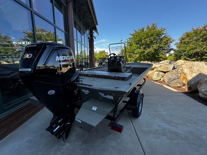 Slide: The Image of 2025 Tracker Grizzly 1860 CC boat with Mercury engine, parked outdoors. - 3