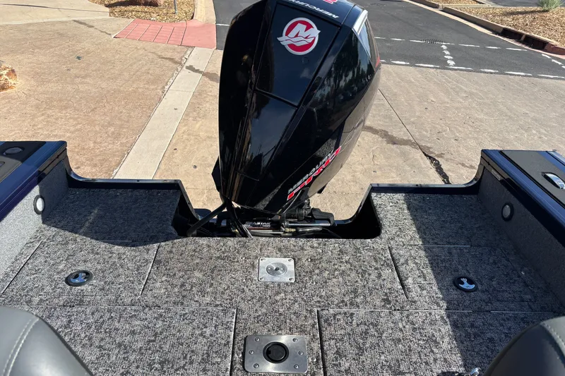 Slide: The Image of 2025 Tracker Targa V-18 WT boat with Mercury outboard motor on a paved surface. - 13