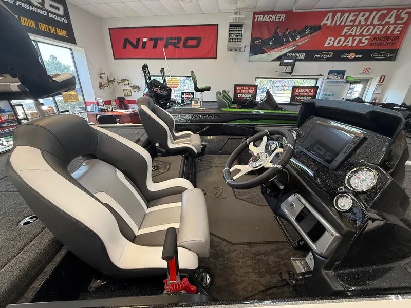 Slide: The Image of 2025 Nitro Z20 XL Pro boat interior with modern dashboard and seating in showroom. - 4