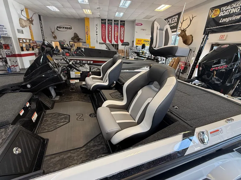 Slide: The Image of 2025 Nitro Z20 XL Pro boat interior with sleek seating and modern dashboard in showroom. - 5