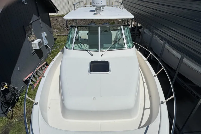 Slide: The Image of 2001 Pursuit 3070 boat with white deck and cabin, viewed from above. - 4