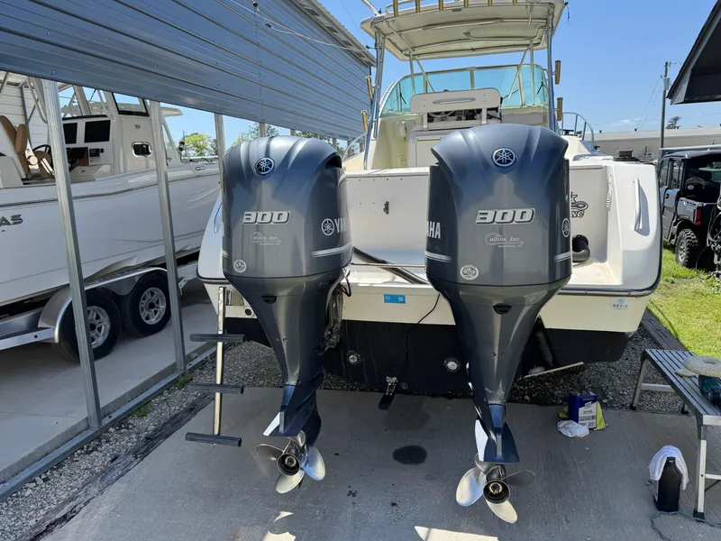 Slide: The Image of 2001 Pursuit 3070 boat with twin Yamaha 300 outboard engines, docked under a metal canopy. - 5