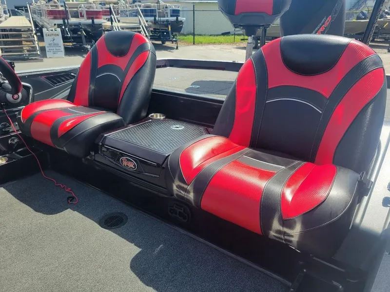 Slide: The Image of 2021 Ranger Z520L boat seats, red and black design, outdoor setting. - 11