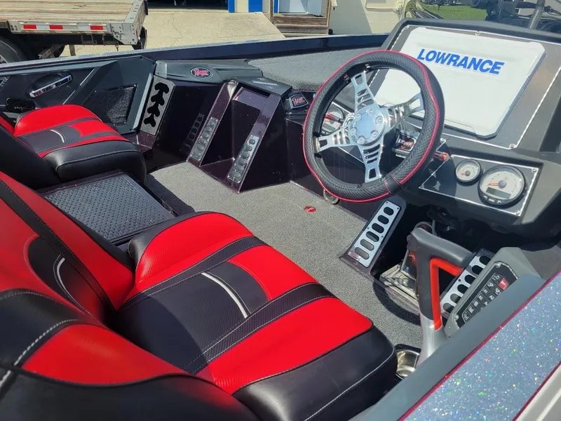 Slide: The Image of 2021 Ranger Z520L boat interior with red and black seats, steering wheel, and Lowrance display. - 14