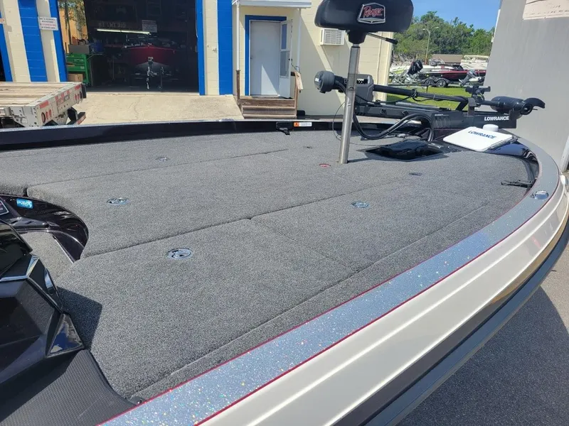 Slide: The Image of 2021 Ranger Z520L boat deck with fishing seat and equipment, parked outdoors. - 15