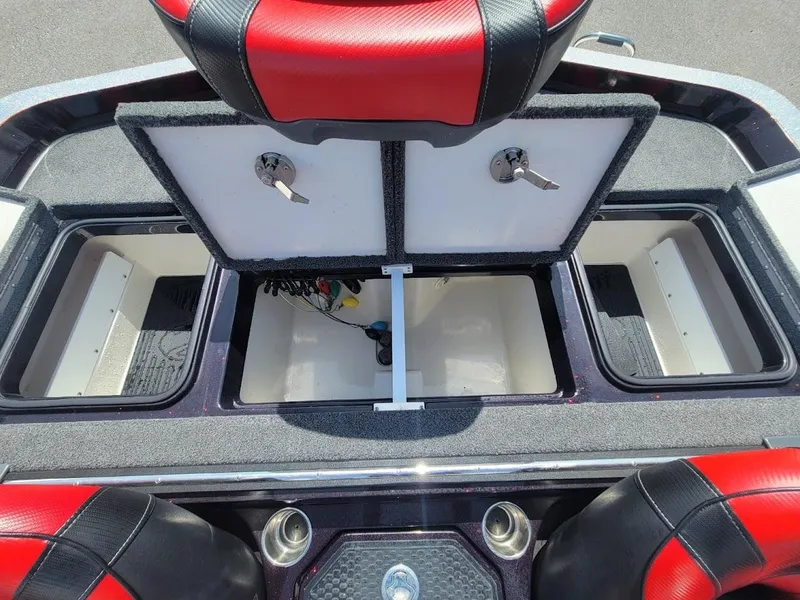 Slide: The Image of 2021 Ranger Z520L boat storage compartments with red and black seats, open for viewing. - 20
