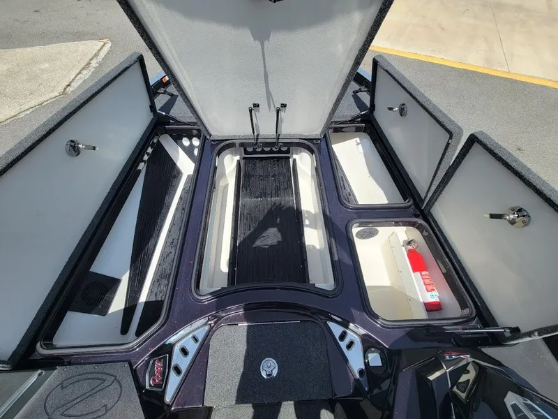 Slide: The Image of 2021 Ranger Z520L boat storage compartments open, showcasing organized interior space. - 22