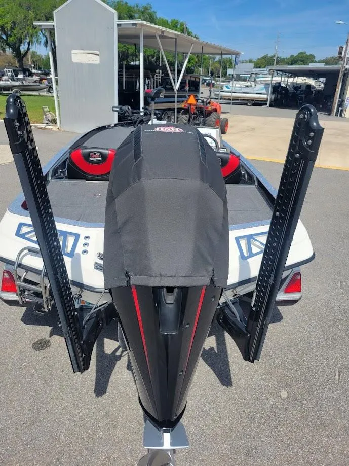 Slide: The Image of 2021 Ranger Z520L boat with dual power poles, parked outdoors. - 7