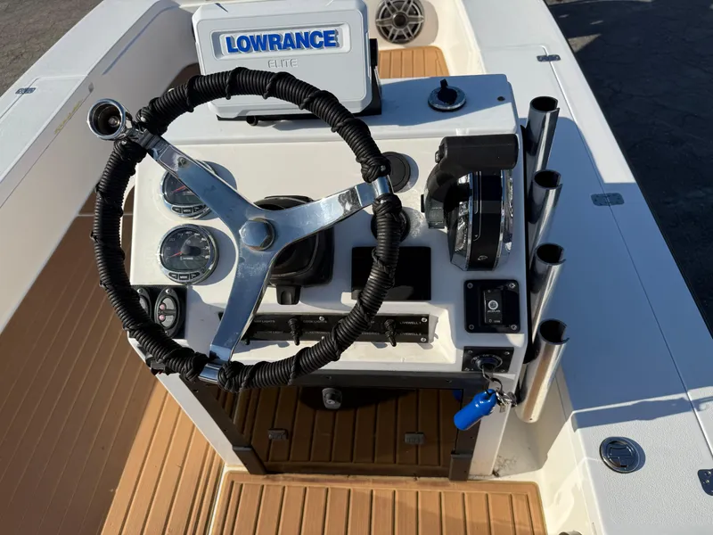 Slide: The Image of 1998 Lake & Bay Boca Grande 20 boat console with steering wheel and Lowrance device. - 10
