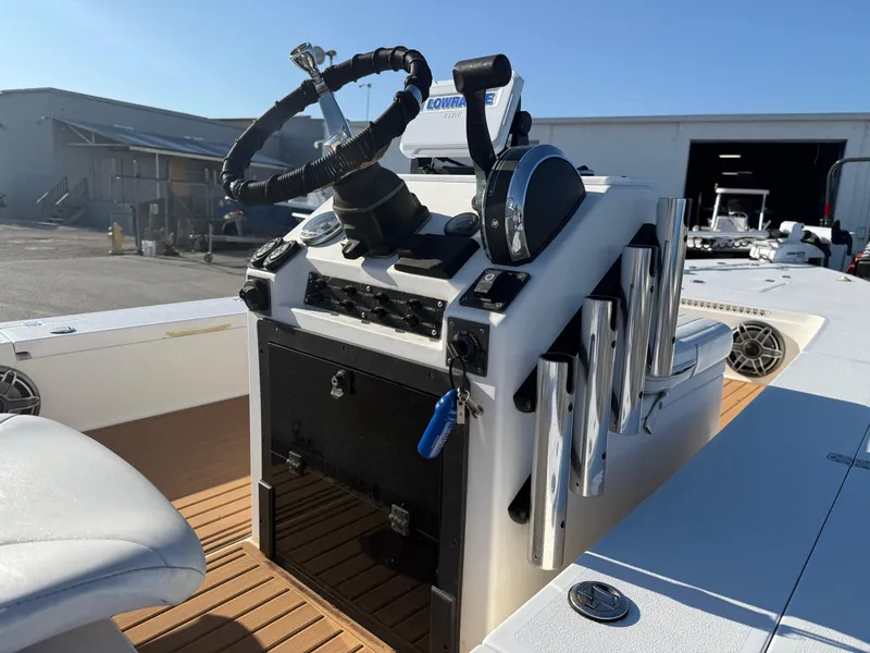 Slide: The Image of 1998 Lake & Bay Boca Grande 20 boat console with steering wheel and controls. - 12