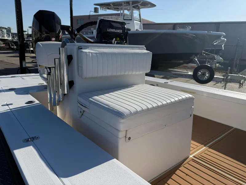 Slide: The Image of 1998 Lake & Bay Boca Grande 20 boat interior with white seating and Lowrance equipment. - 16