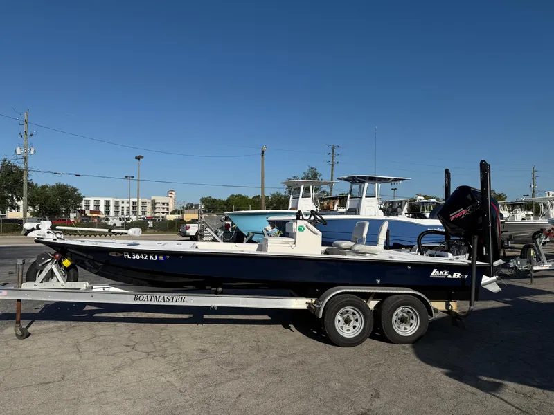 Slide: The Image of 1998 Lake & Bay Boca Grande 20 boat on trailer in parking lot. - 2