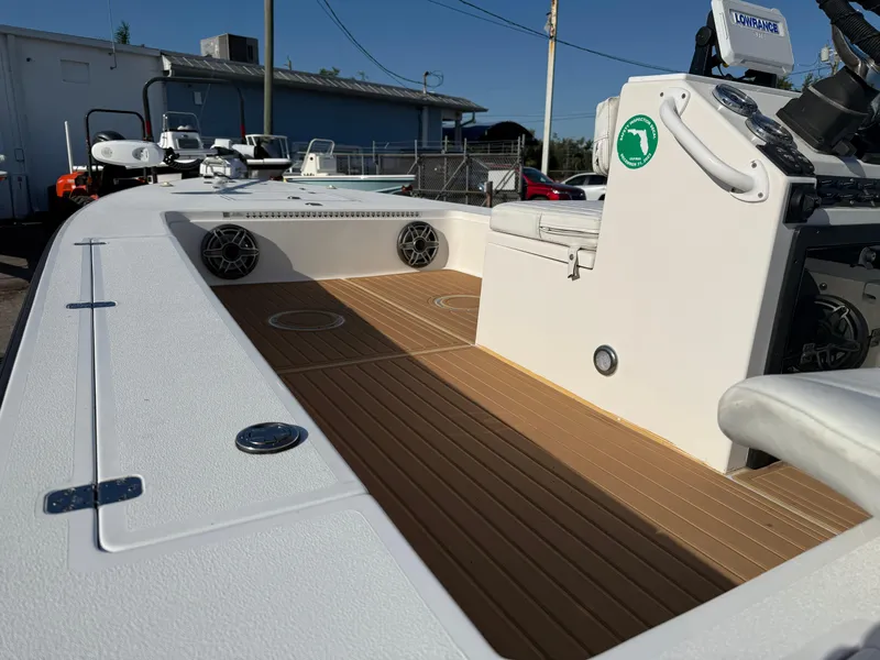 Slide: The Image of 1998 Lake & Bay Boca Grande 20 boat interior with teak flooring and modern controls. - 3