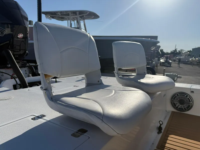 Slide: The Image of 1998 Lake & Bay Boca Grande 20 boat seats, white upholstery, outdoor setting. - 5