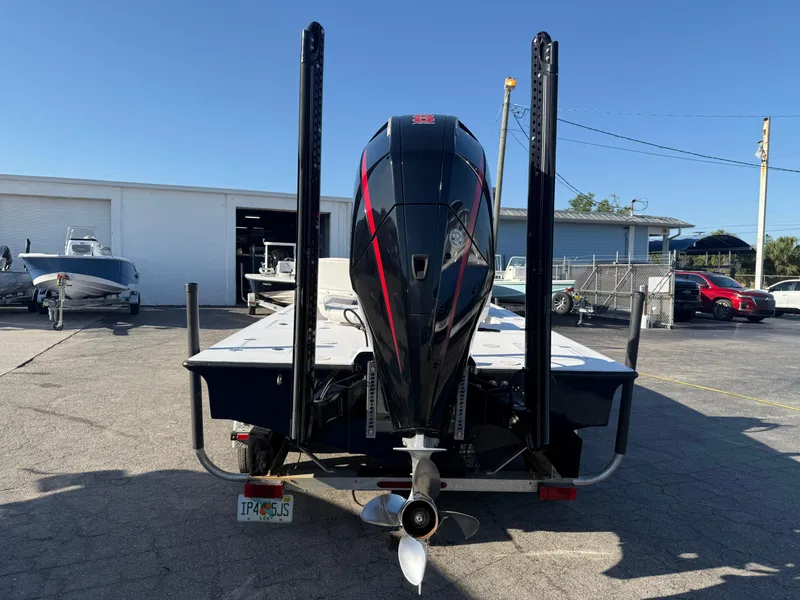 Slide: The Image of 1998 Lake & Bay Boca Grande 20 boat with powerful outboard motor, parked outdoors. - 8