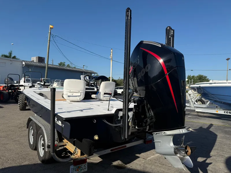 Slide: The Image of 1998 Lake & Bay Boca Grande 20 boat on trailer, featuring powerful outboard motor. - 9
