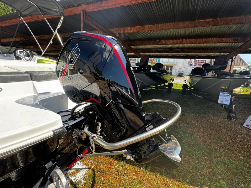 Slide: The Image of 2011 Tahoe Q7i boat with outboard motor under a metal canopy. - 17