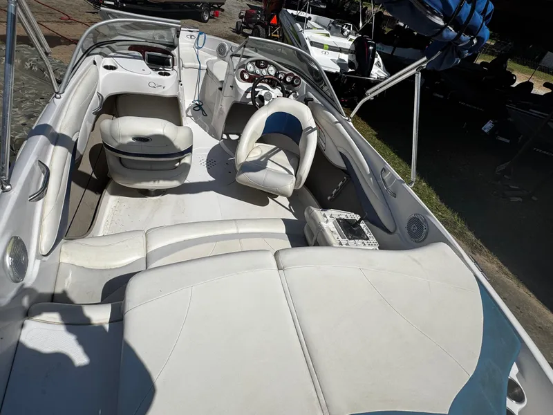 Slide: The Image of 2011 Tahoe Q7i boat interior with white seating and steering console. - 20