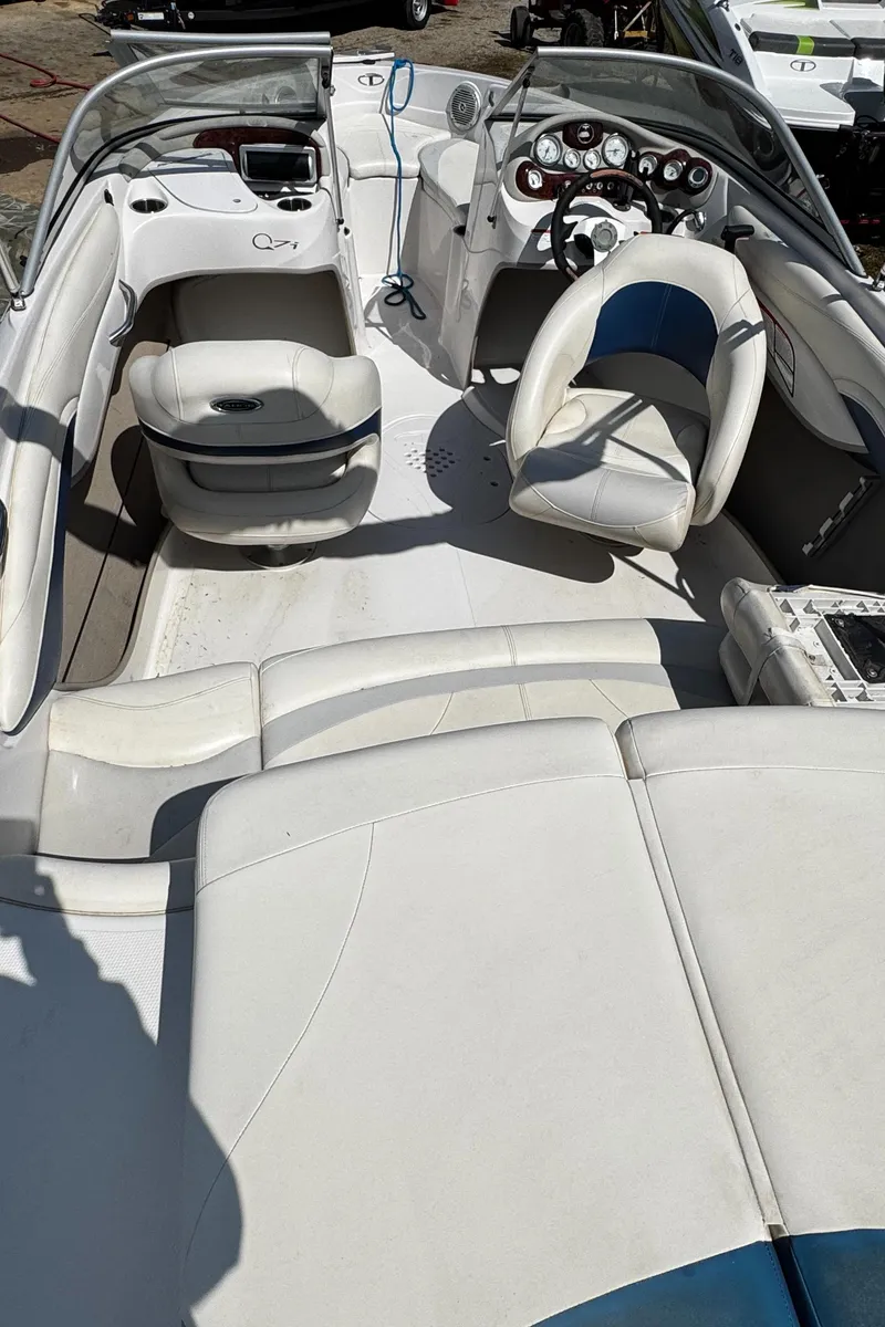 Slide: The Image of 2011 Tahoe Q7i boat interior with white seating and dashboard. - 23
