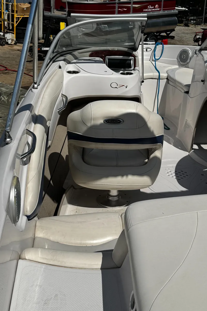 Slide: The Image of 2011 Tahoe Q7i boat interior with white seating and steering console. - 25