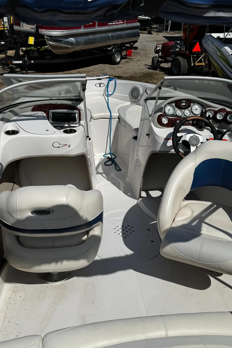 Slide: The Image of 2011 Tahoe Q7i boat interior with white seating and dashboard controls. - 26