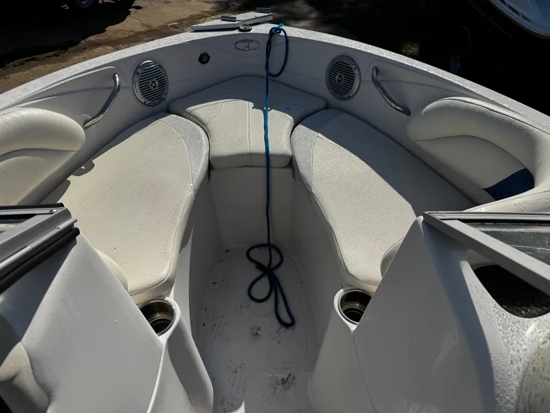 Slide: The Image of Interior of a 2011 Tahoe Q7i boat with cushioned seating and cup holders. - 29