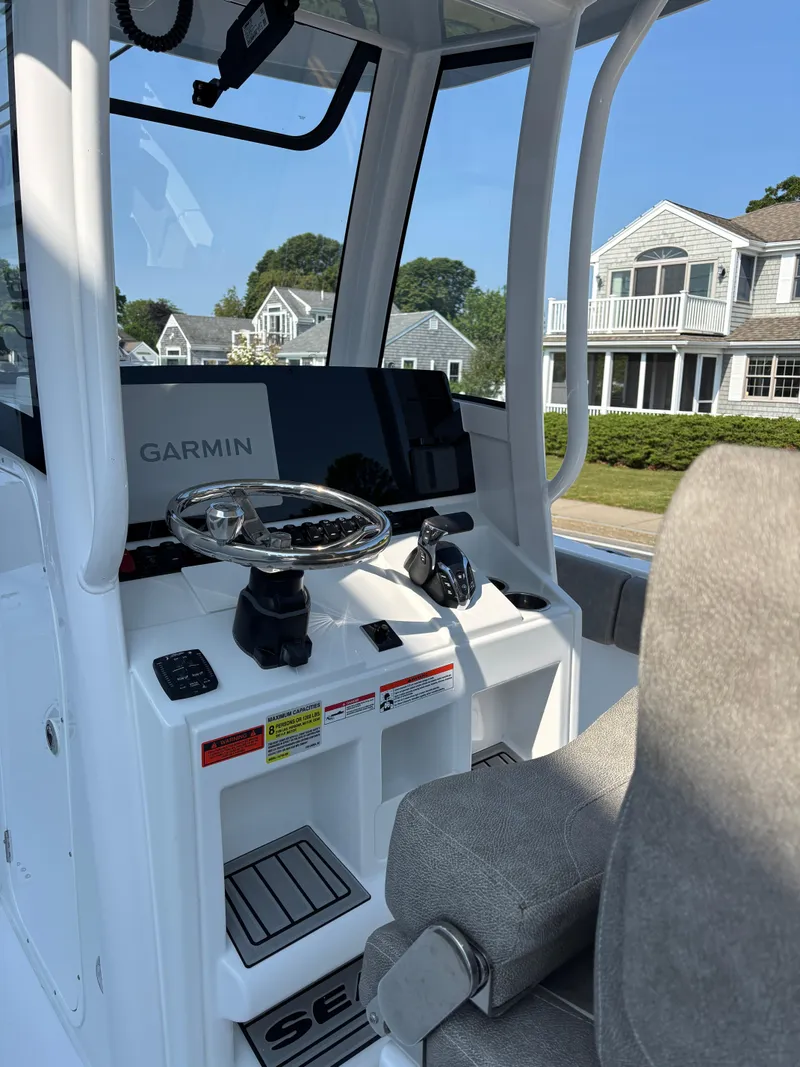 Slide: The Image of 2026 Sea Hunt Ultra 235 SE boat cockpit with Garmin navigation system. - 4