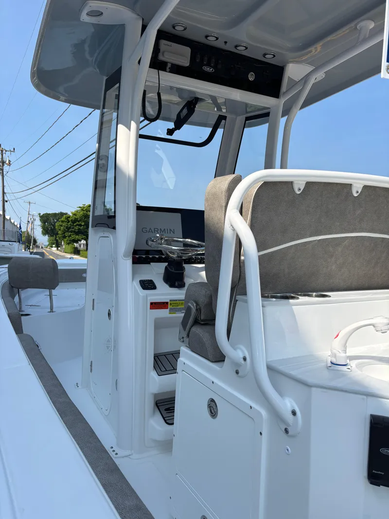 Slide: The Image of 2026 Sea Hunt Ultra 235 SE boat interior with modern seating and navigation equipment. - 5