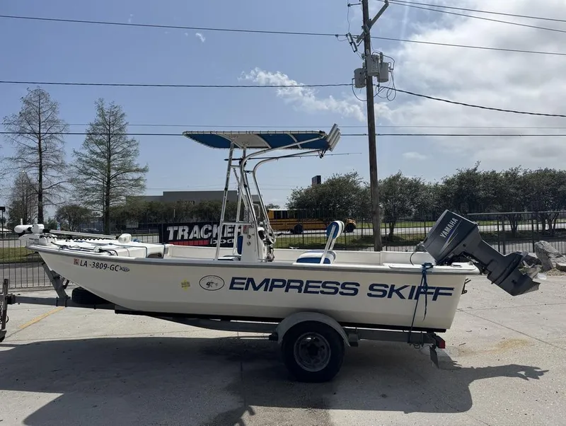 Slide: The Image of 2010 Carolina Skiff DLV 178 boat on trailer, labeled "Empress Skiff," with Yamaha outboard motor. - 11