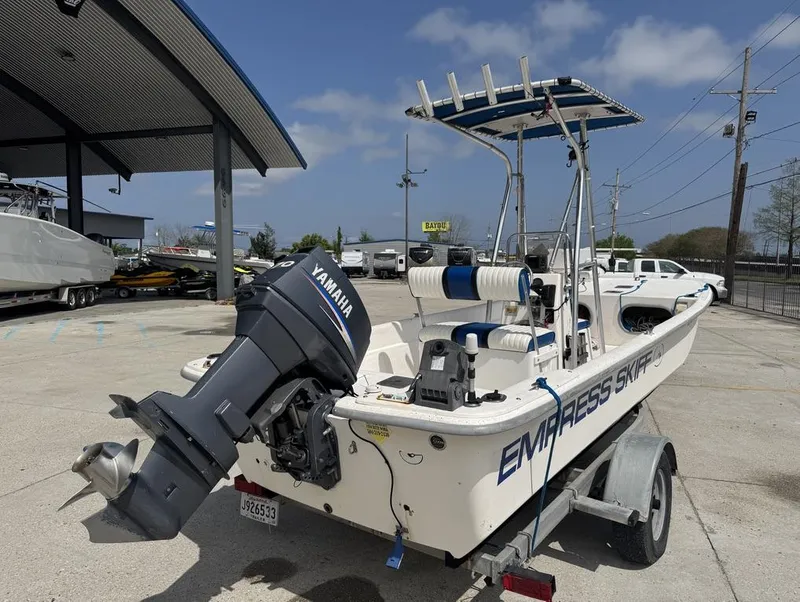 Slide: The Image of 2010 Carolina Skiff DLV 178 boat with Yamaha motor on a trailer in a parking lot. - 13