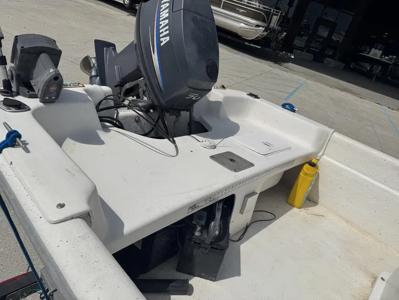 Slide: The Image of 2010 Carolina Skiff DLV 178 boat with Yamaha motor, docked outdoors. - 16