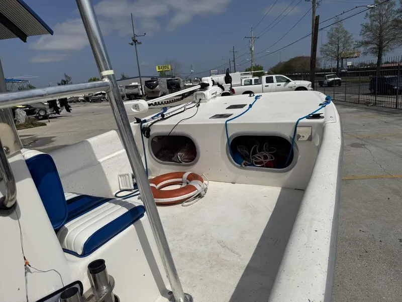 Slide: The Image of 2010 Carolina Skiff DLV 178 boat with blue seating and storage compartments. - 7