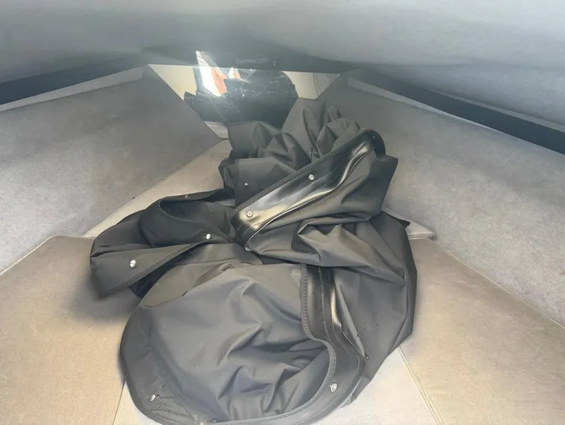 Slide: The Image of Interior of 1990 Rinker 206 Captiva Cuddy with black fabric cover. - 10