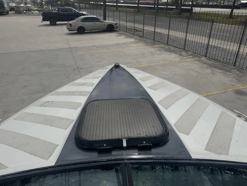 Slide: The Image of Bow view of 1990 Rinker 206 Captiva Cuddy boat in a parking lot. - 11