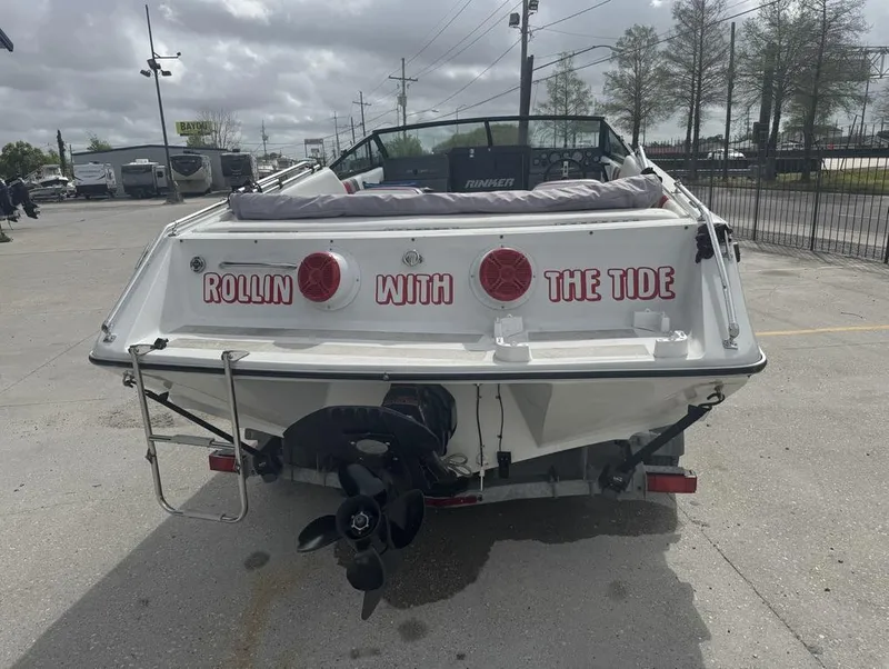 Slide: The Image of 1990 Rinker 206 Captiva Cuddy boat with "Rollin with the Tide" text on the stern. - 12