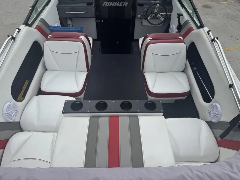 Slide: The Image of 1990 Rinker 206 Captiva Cuddy interior with white and red seating, steering wheel, and cup holders. - 8